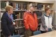 Three People in Front of Book Shelf