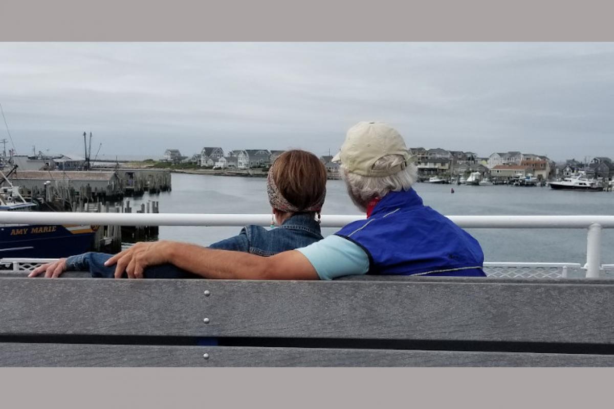 Couple Sitting on Bench by the Water